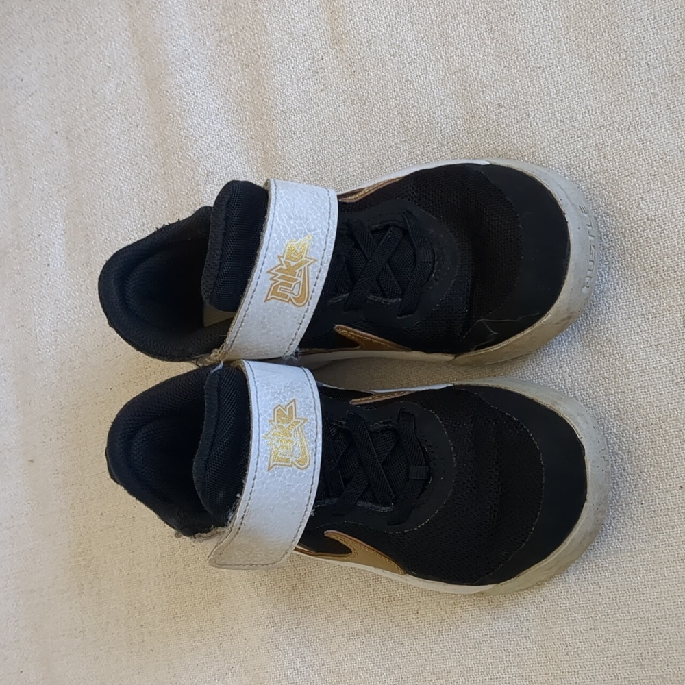 Nike kids basketball sneakers size us12 black and gold